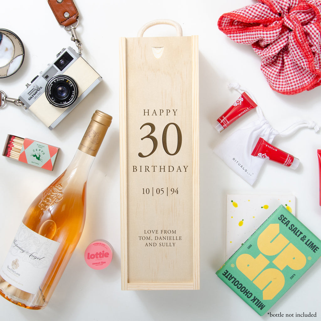A personalised wooden wine box with a bottle of wine and a camera, alongside a happy birthday message, indicating it is a gift for a 30-year-old.